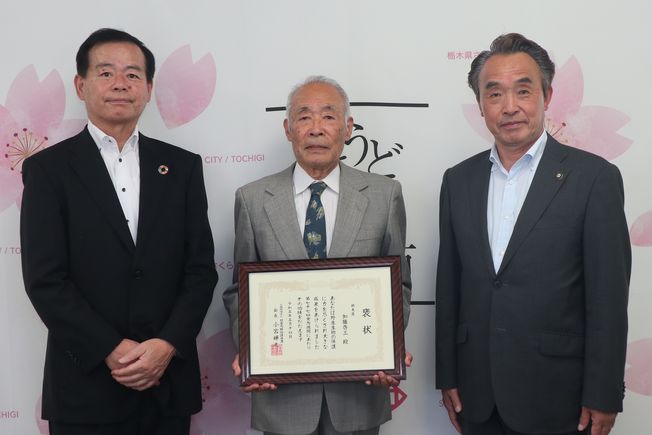 褒状を受賞された加藤さんと市長、教育長の写真